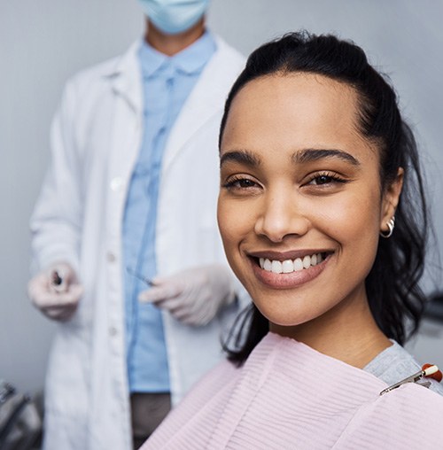 Smiling woman sitting in dental treatment chair