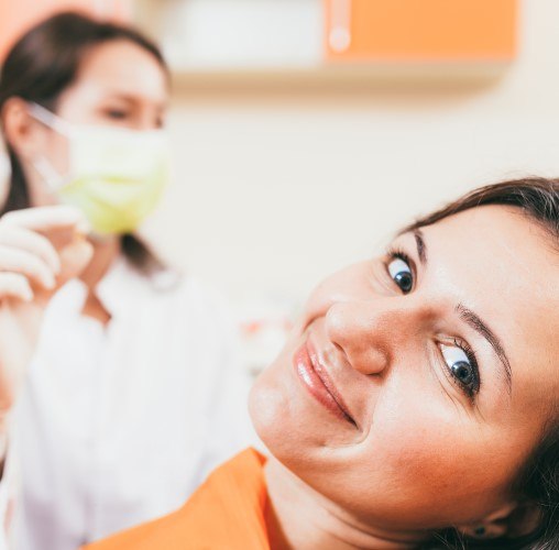 Patient in Colorado Springs smiling with their dentist