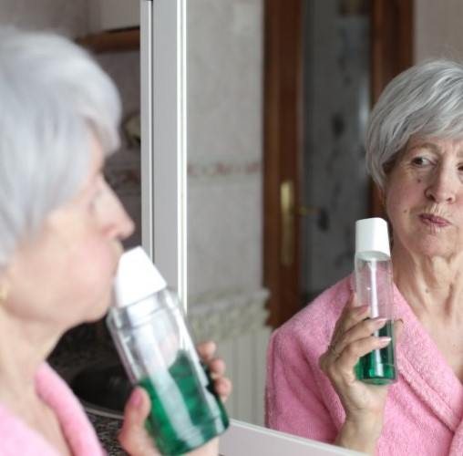 Patient in Colorado Springs rinsing to prevent dental emergencies