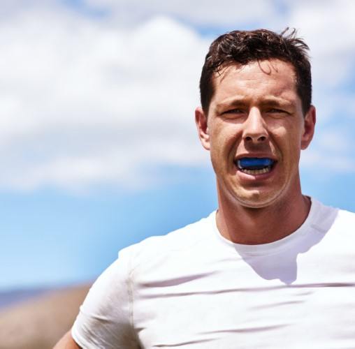 Patient in Colorado Springs with mouth guard reducing dental emergencies