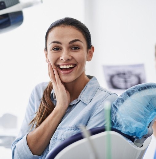 Woman smiling in dental chair thanks to root canal treatment in Colorado Springs